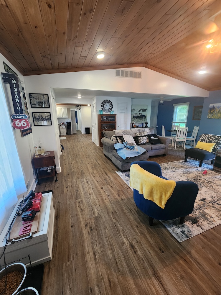 Interior wood flooring installation living room home remodel — completed by 848 Property Services in Hastings, MI.