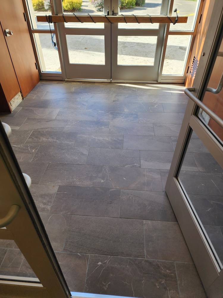 Interior tile flooring installation front office entryway — completed by 848 Property Services in Hastings, MI.