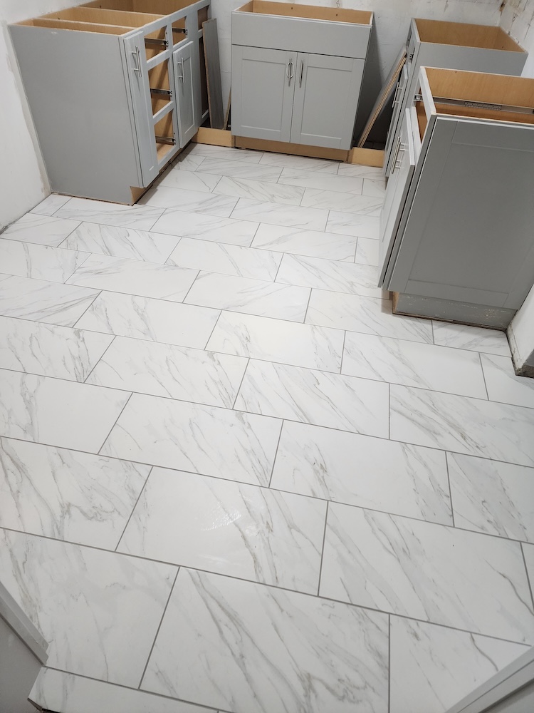 Interior tile flooring installation kitchen remodel angle — completed by 848 Property Services in Hastings, MI.