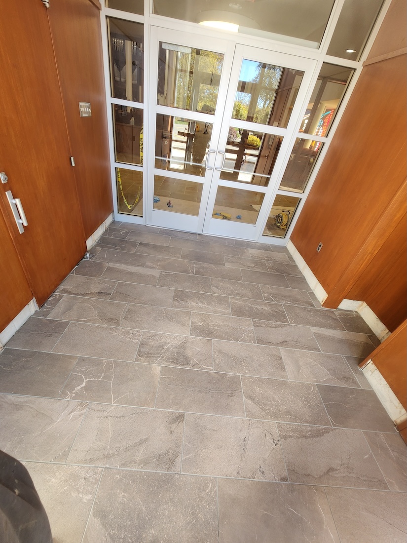 Interior tile flooring installation office entryway — completed by 848 Property Services in Hastings, MI.