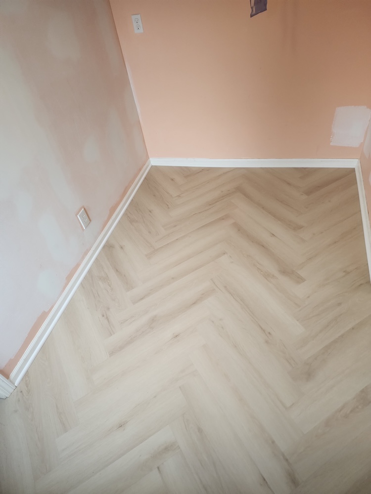 Interior luxury vinyl plank herringbone style vinyl flooring dining room remodel — completed by 848 Property Services in Hastings, MI.