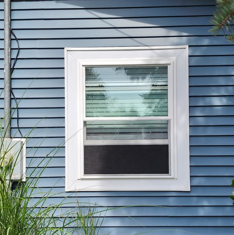 Exterior white window frame replacement home remodel — completed by 848 Property Services in Hastings, MI.