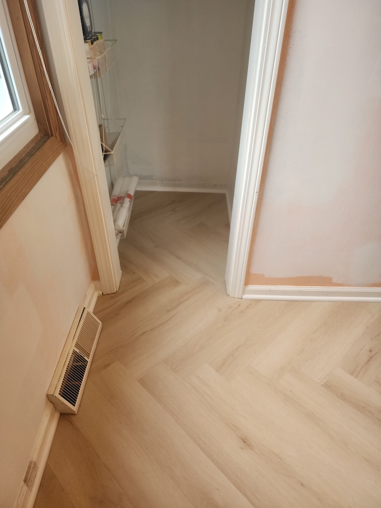 Interior luxury vinyl plank herringbone style vinyl flooring closet remodel — completed by 848 Property Services in Hastings, MI.